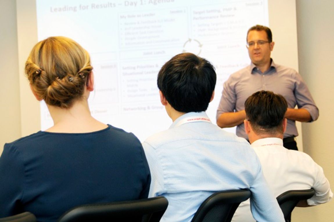 Leadership for results training session with speaker and attendees listening