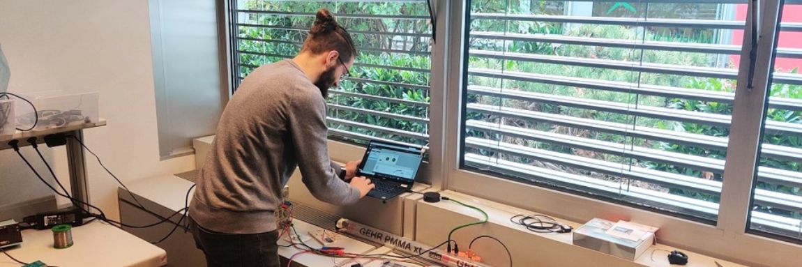 Pewatron office indoor view with employee working on sensor project