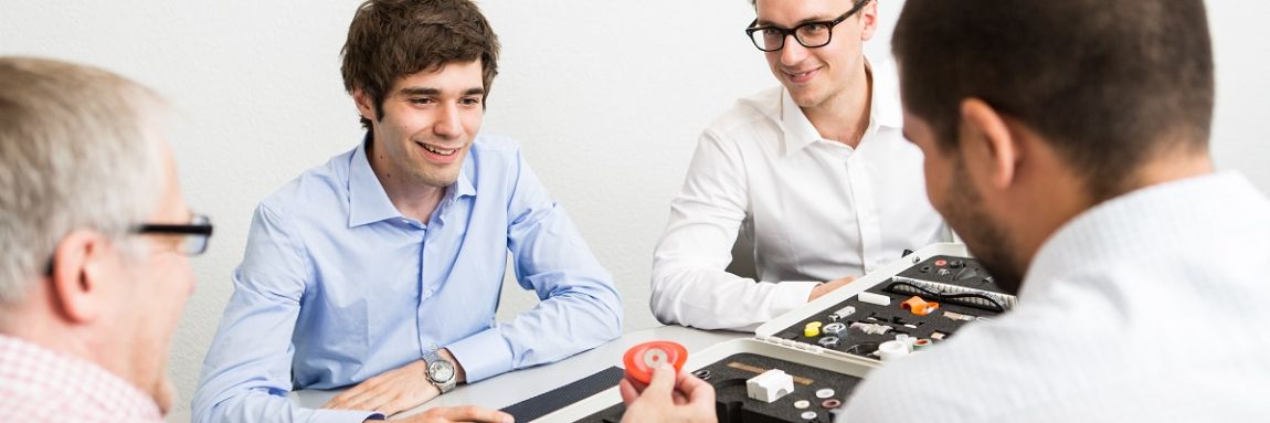 Product application engineer job profile: employees showing off product samples to customers