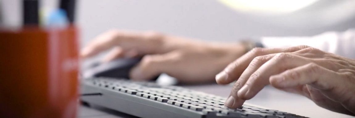 Close-up of employee typing on keyboard