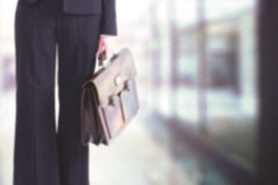 Professional employee holding a suitcase