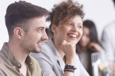 Students smiling and interacting in workplace environment