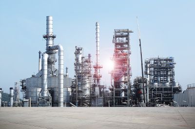 Oil and gas industry: manufacturing plant with sunny sky in the background