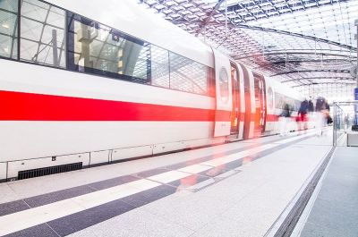 Railway industry: train arriving in light-flooded train station with motion blur 